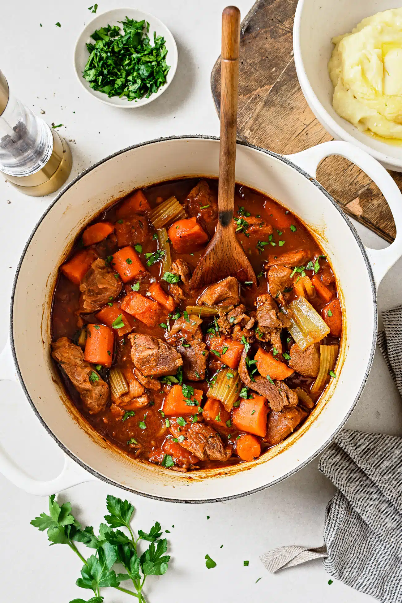 Lamb stew in a white Dutch oven. 