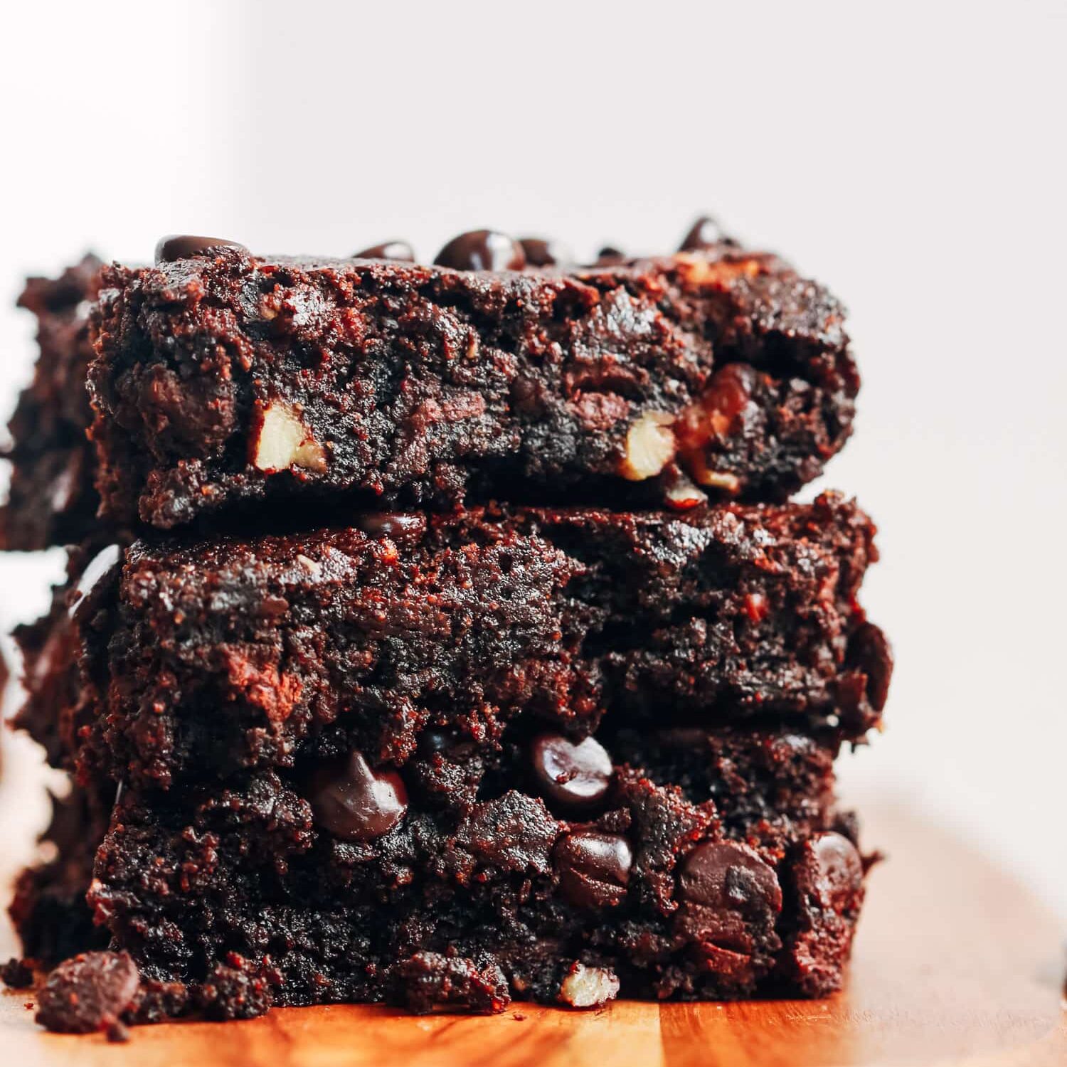 A stack of 3 gluten-free fudgy walnut brownies. 