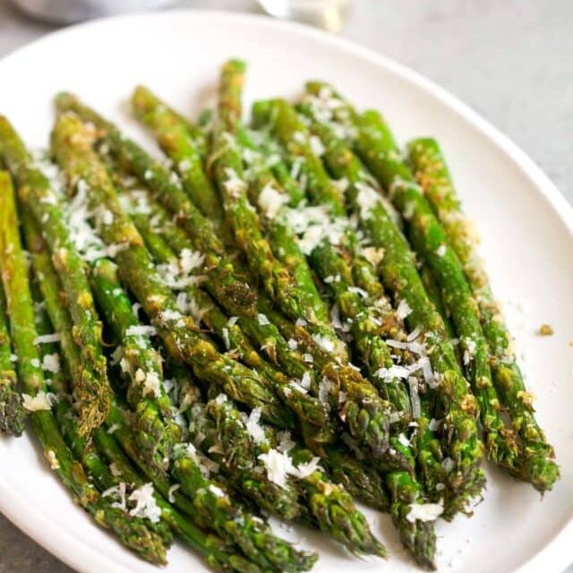 Air fryer asparagus with parmesan cheese on top. 