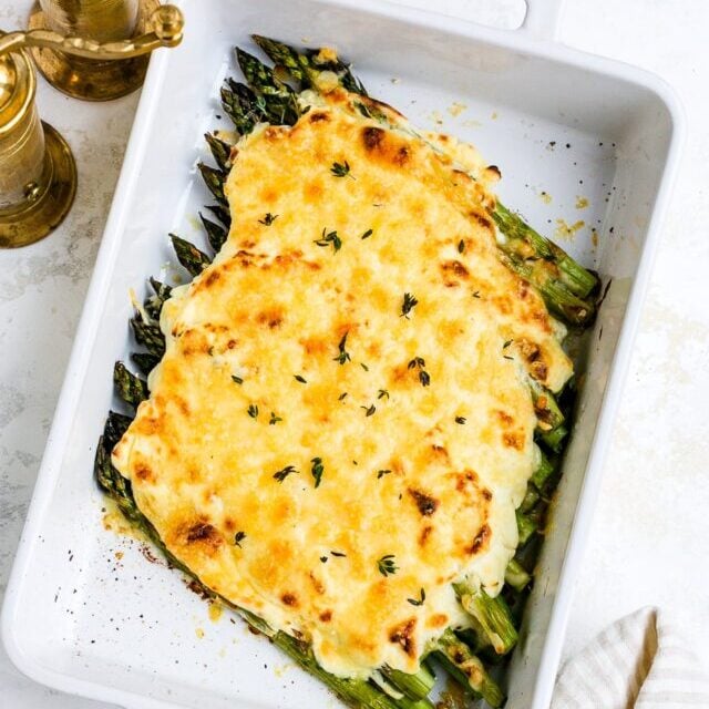 Asparagus casserole in a white baking dish. 