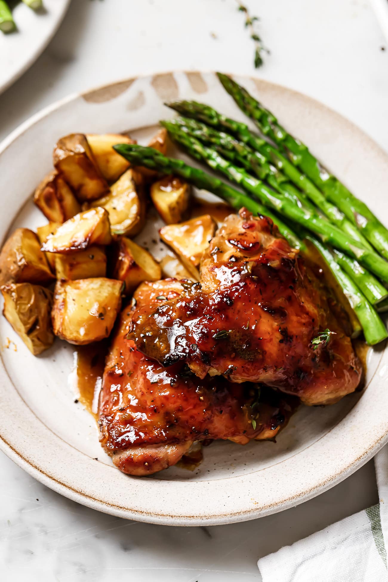 Honey Mustard Chicken on a plate with asparagus and potatoes.