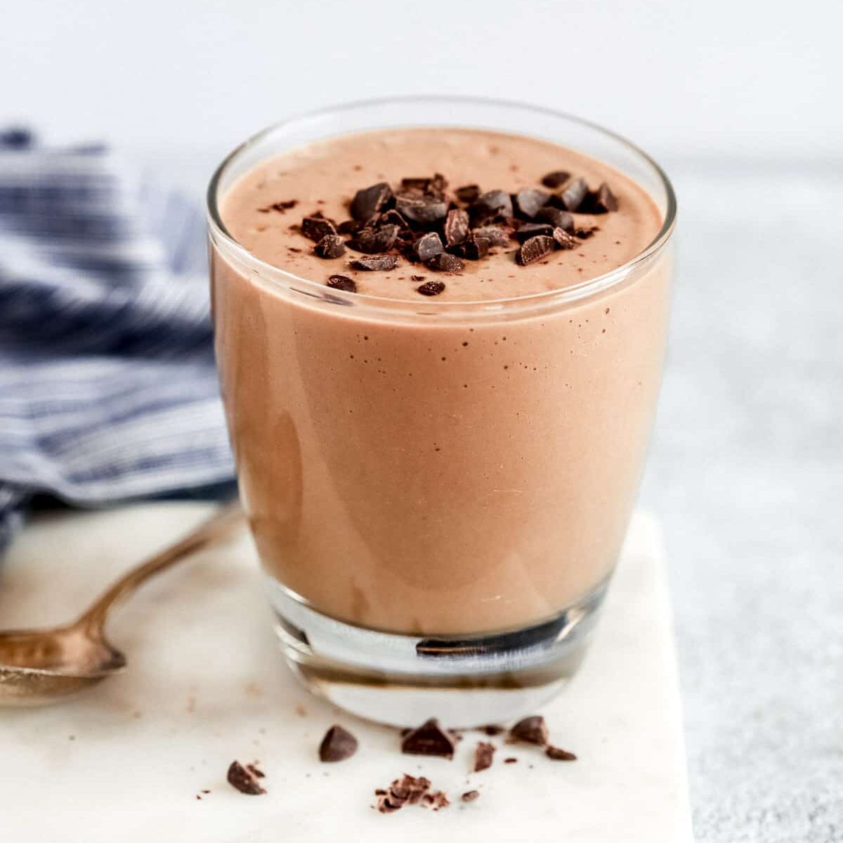 Low-carb chocolate smoothie in a glass. topped with chocolate chips. 