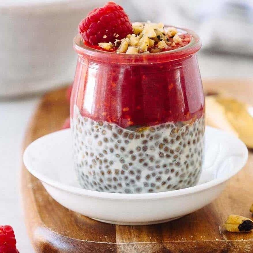 A glass dish with raspberry chia seed pudding. 