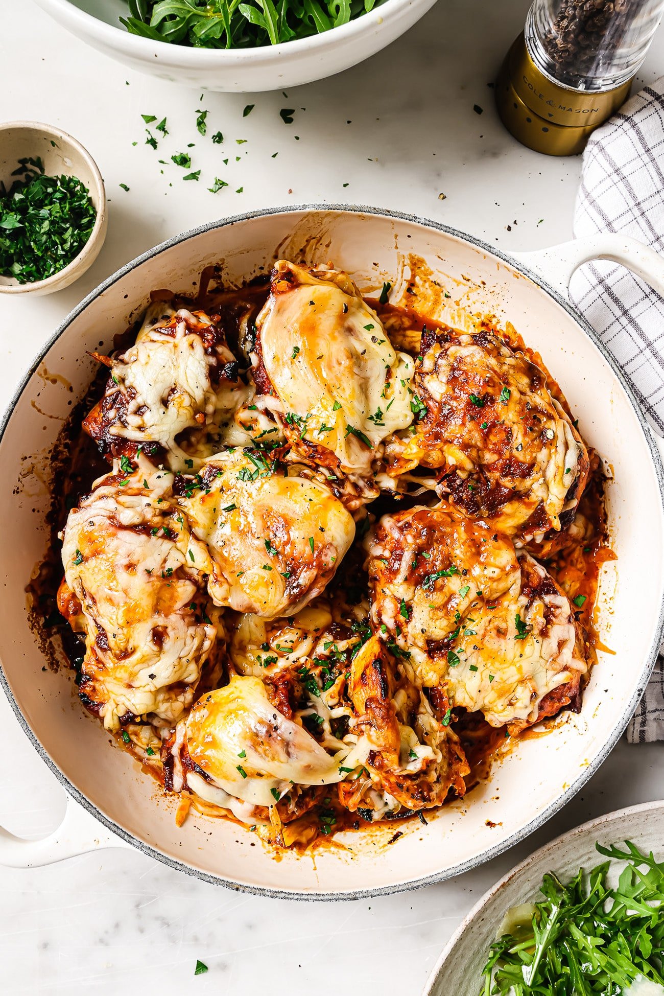 Spinach and feta stuffed chicken in a baking dish.