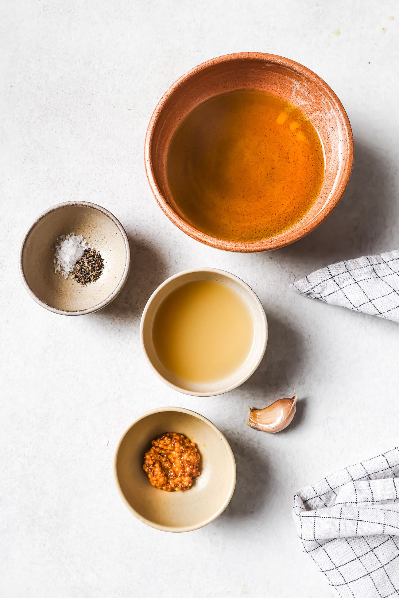 Small bowls of pre-measured ingredients on a white countertop.