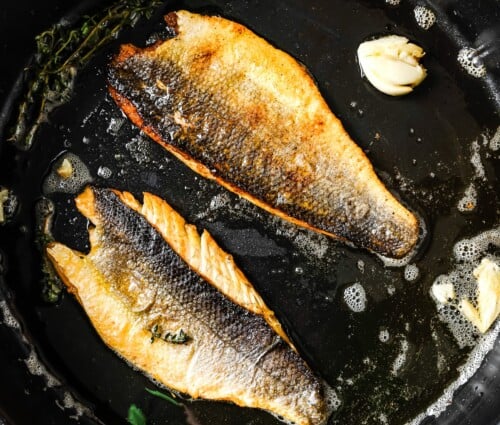 cooked sea bass in a skillet