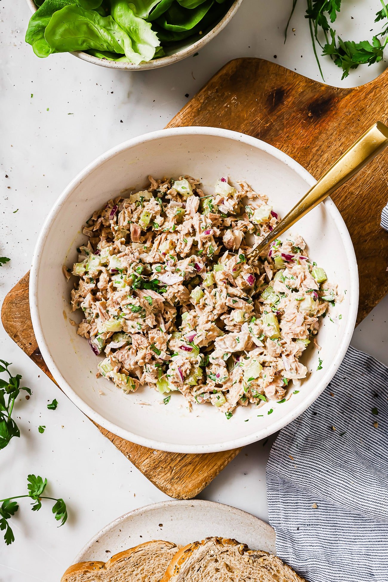 An overhead view of tuna salad in a white serving bowl.