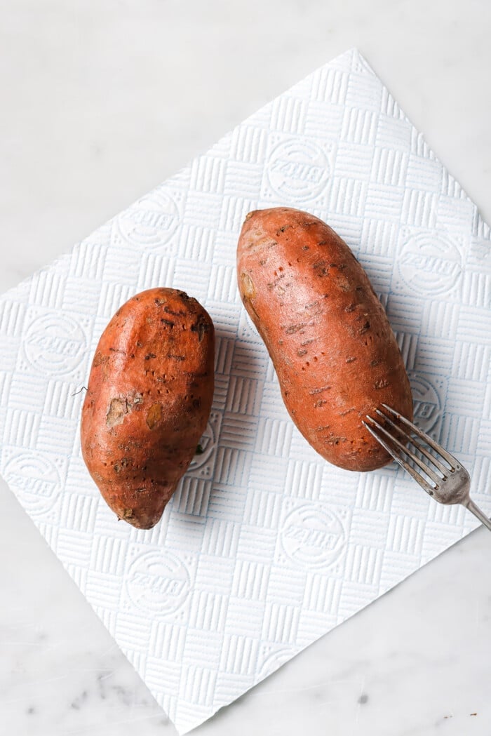 two sweet potatoes on a countertop