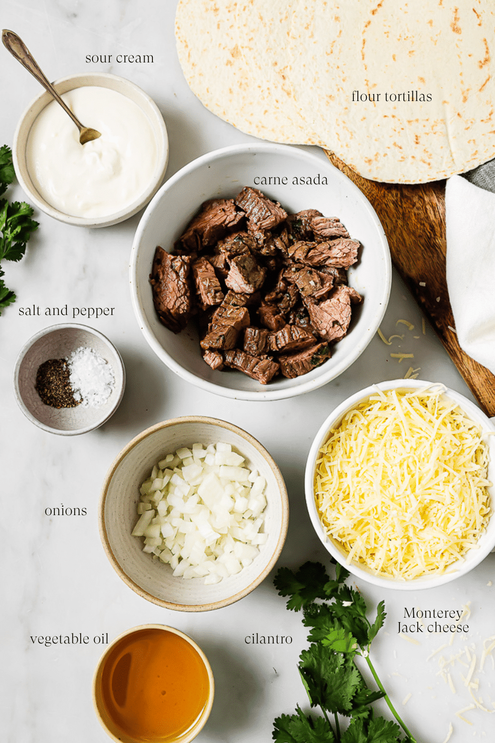 An overhead view of prepped ingredients on a white countertop.