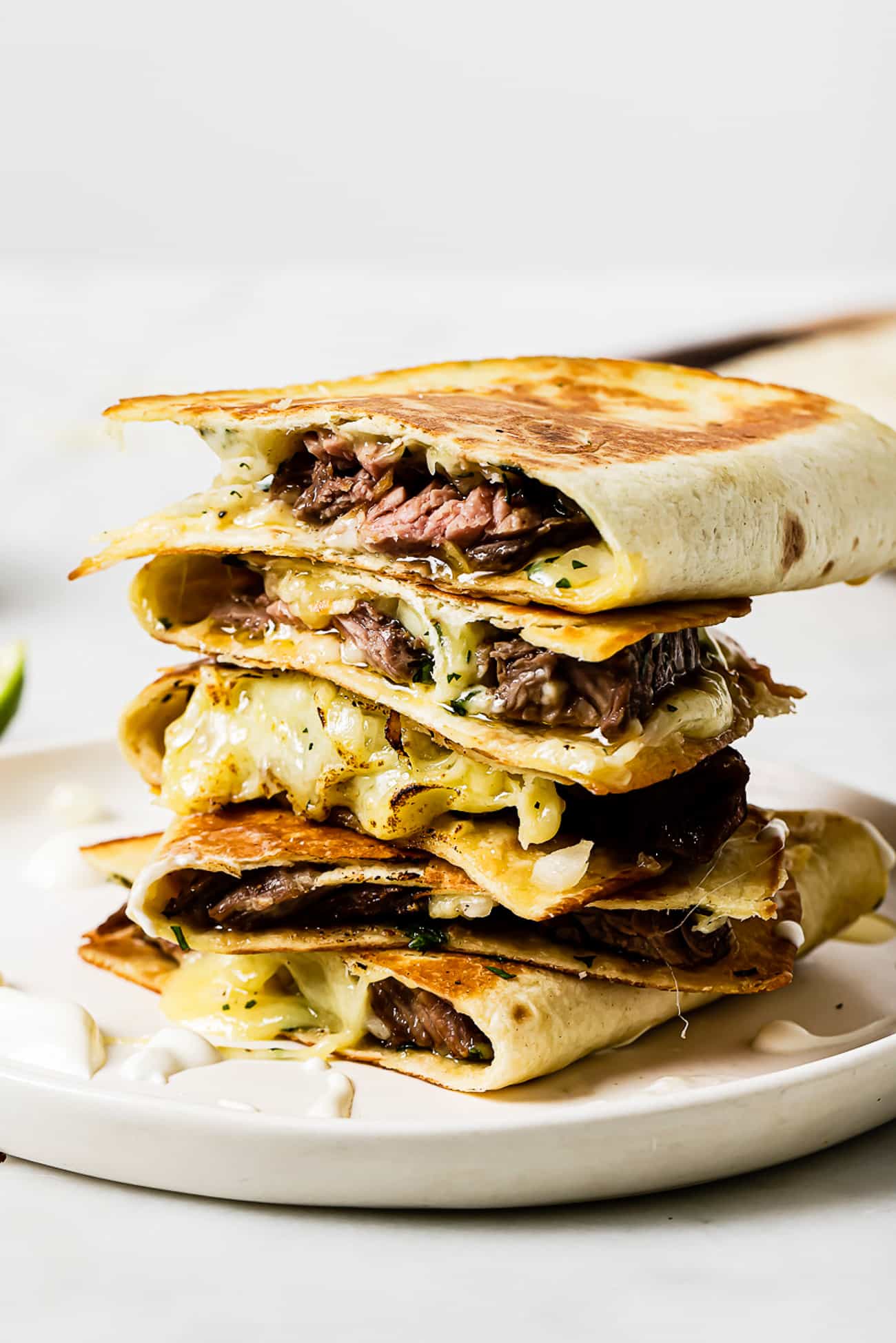 Carne Asada Quesadillas sliced and stacked on top of each other.