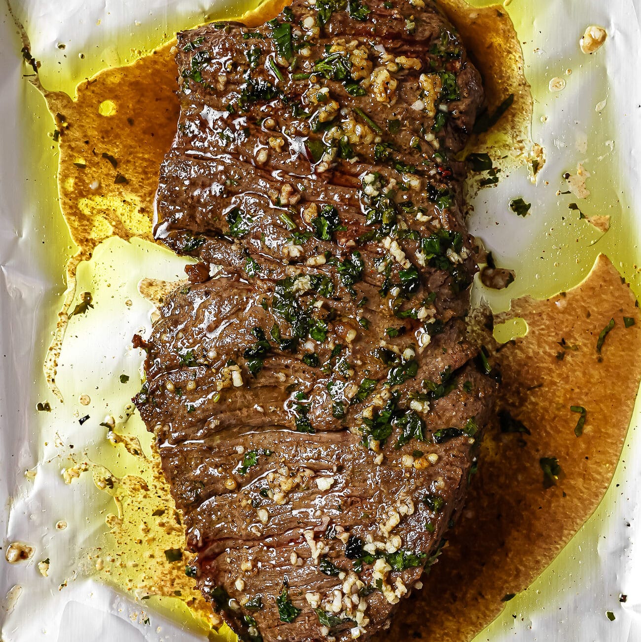 Baked carne asada on a foil-lined baking sheet.