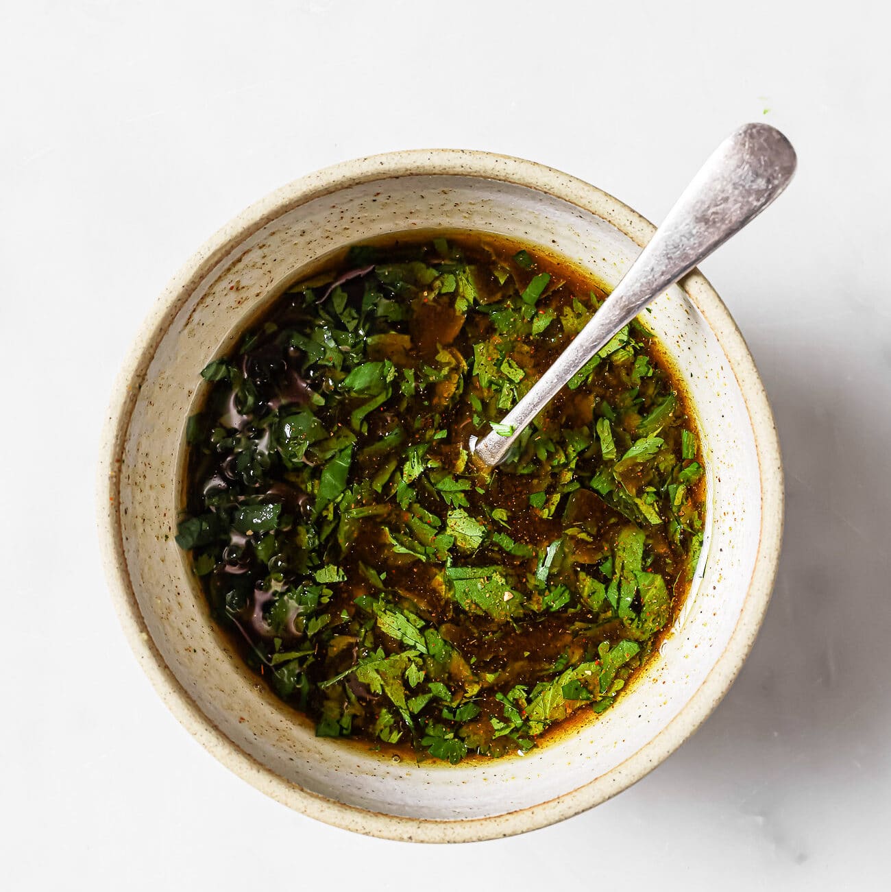 An overhead view of carne asada marinade in a mixing bowl.