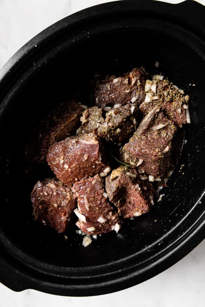 Beef tossed in seasonings and bay leaves added. 