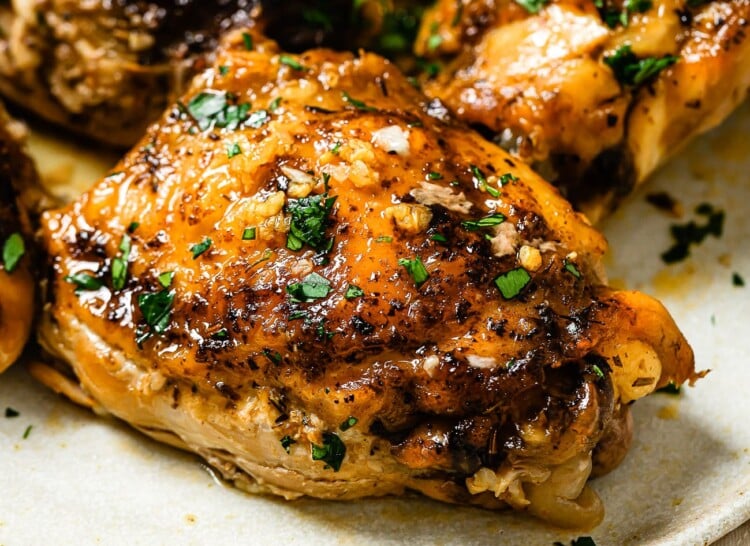 closeup view of chicken thighs on a white plate