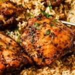 rice and chicken thighs in a white casserole