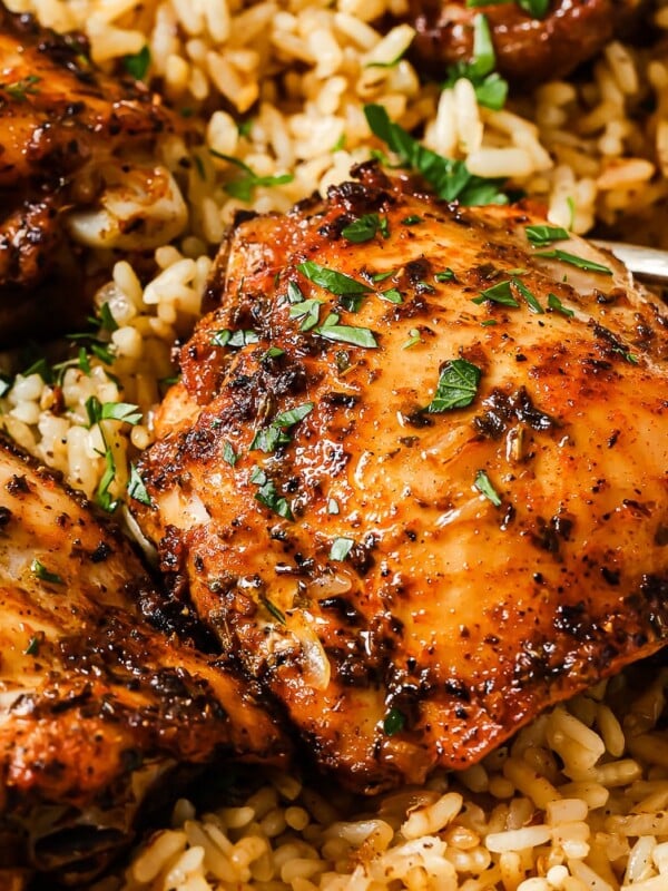 rice and chicken thighs in a white casserole