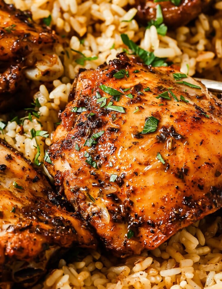 rice and chicken thighs in a white casserole