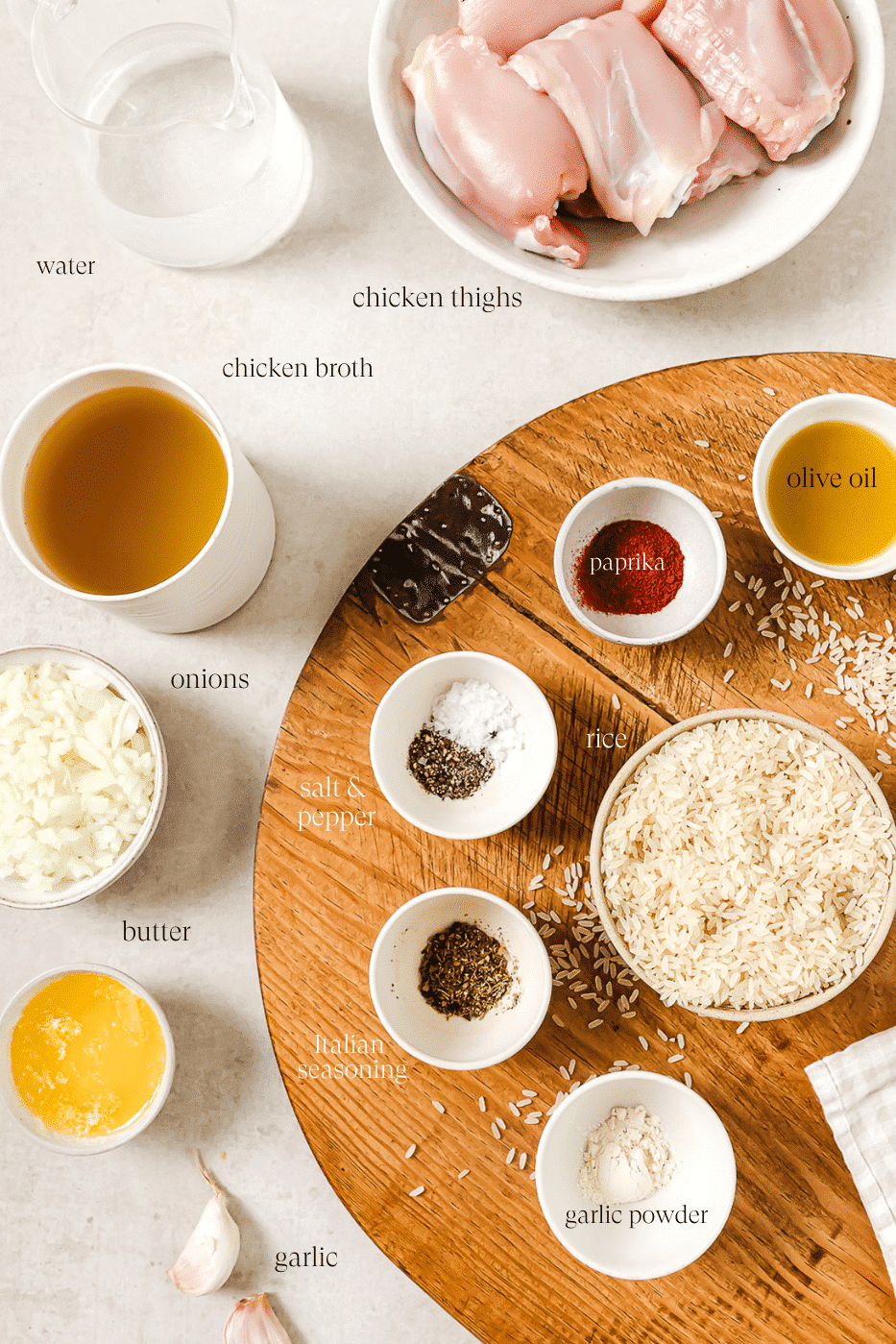 An overhead view of pre-measured ingredients on a wooden cutting board.