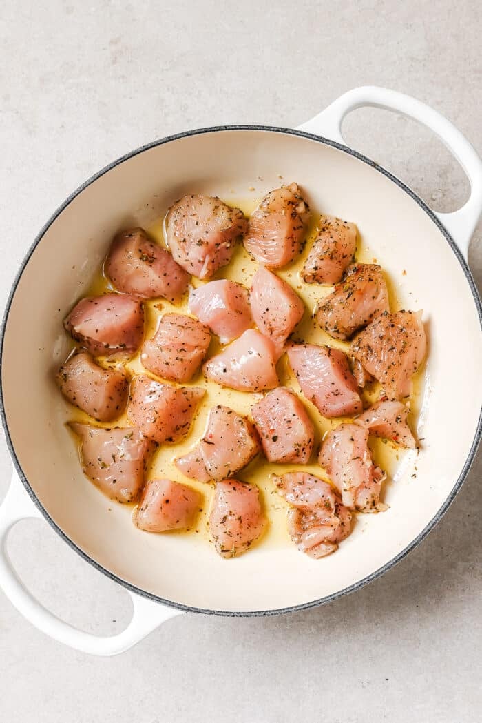 Raw chicken in a skillet