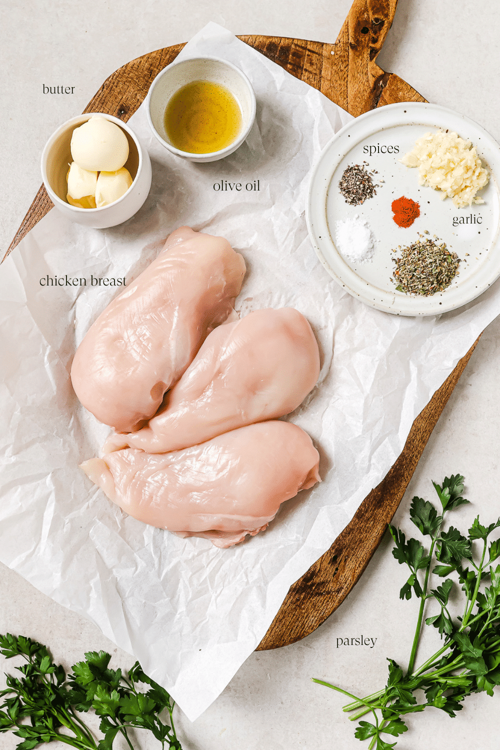 Pre-measured ingredients for garlic butter chicken bites with text overlays labeling each one.
