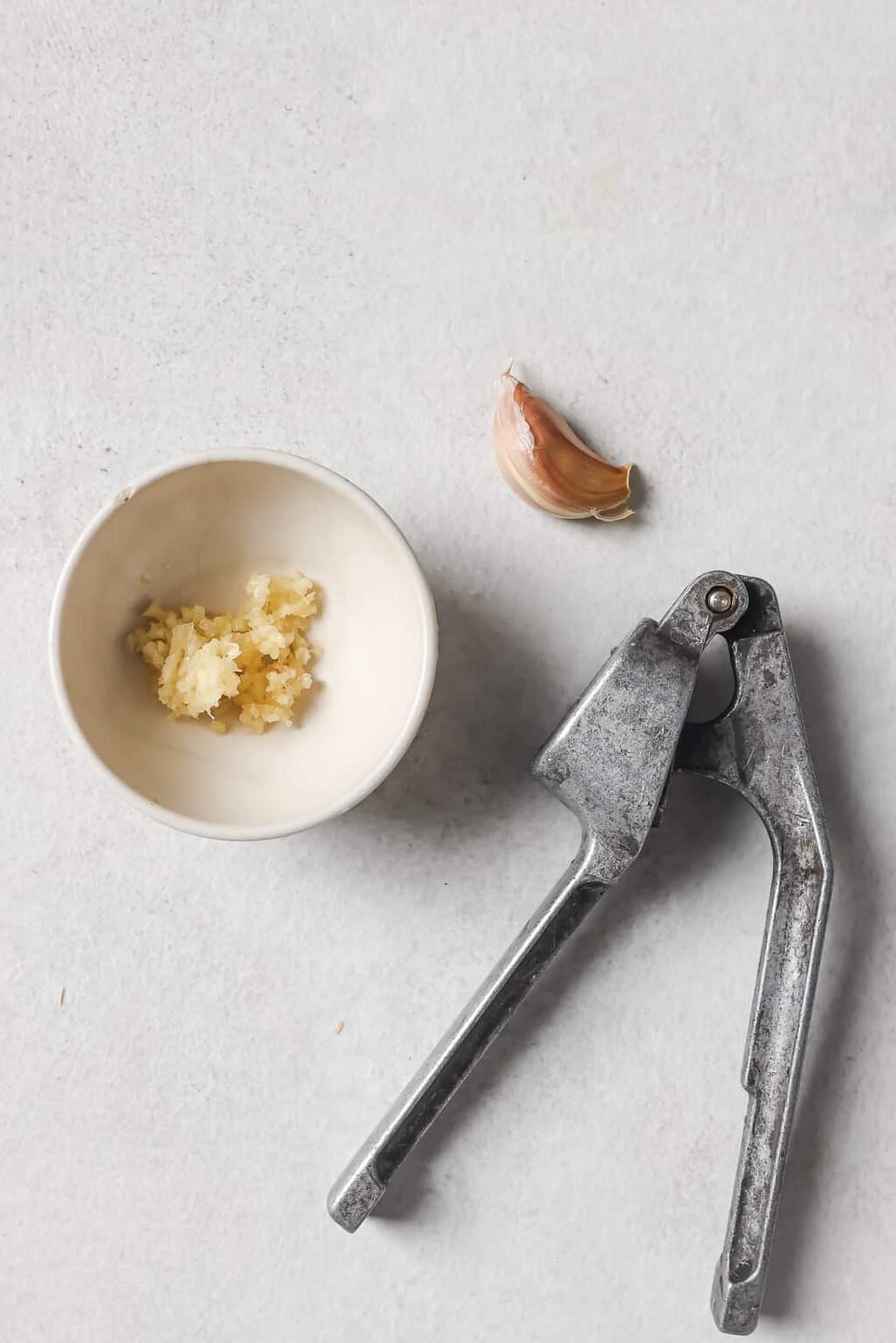 crushed garlic in a white bowl 