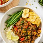 overhead view of Picadillo recipe in a white bowl with green beans and rice