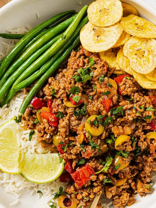 overhead view of Picadillo recipe in a white bowl with green beans and rice