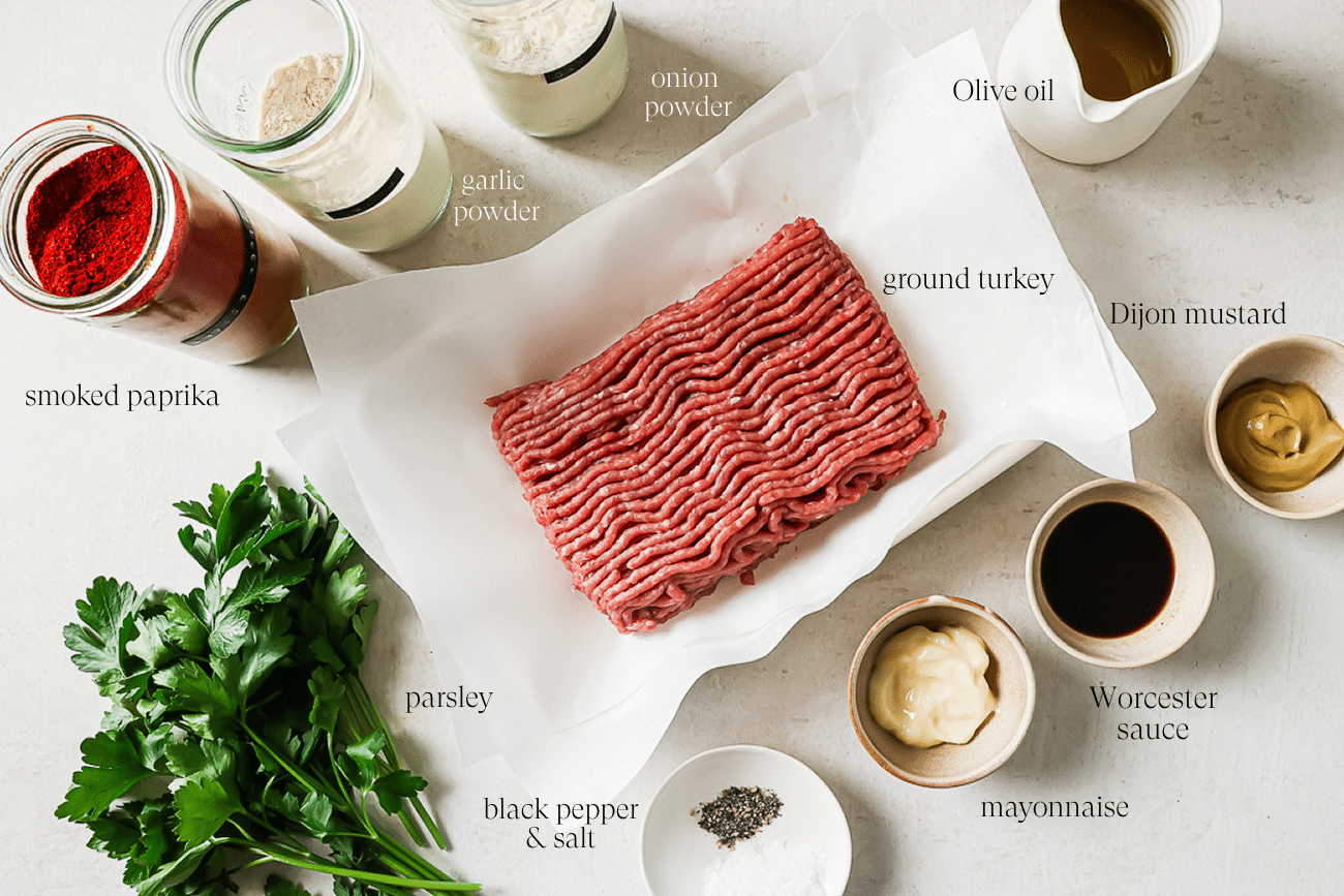 An overhead view of pre-measured and labeled ingredients on a white countertop.