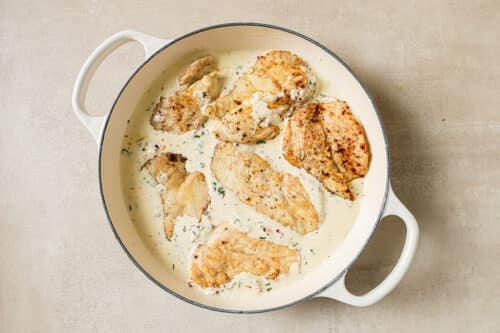 chicken breast and white sauce in a braiser