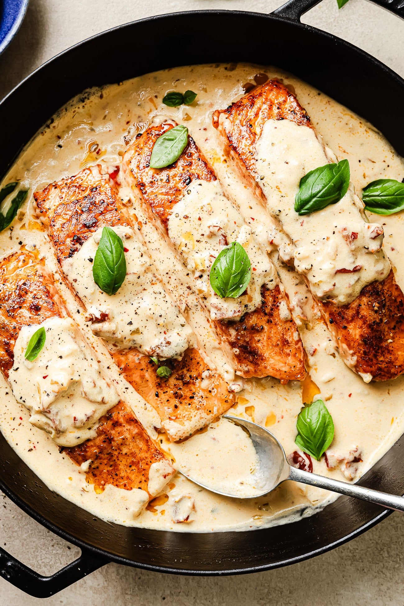 Overhead view of Marry Me Salmon in a cast-iron skillet.
