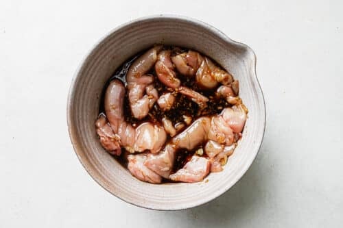 a large bowl with chicken and teriyaki sauce