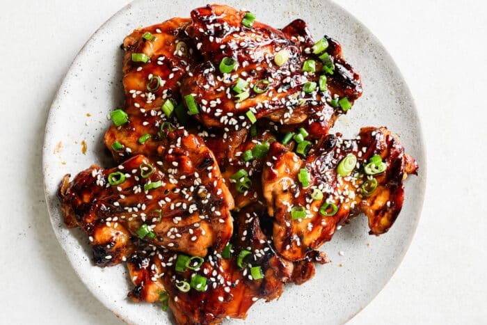 Teriyaki marinated chicken on a white serving plate.