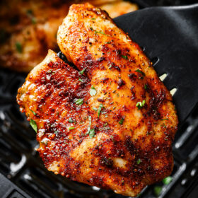 Close-up of a tilapia fillet on a spatula.