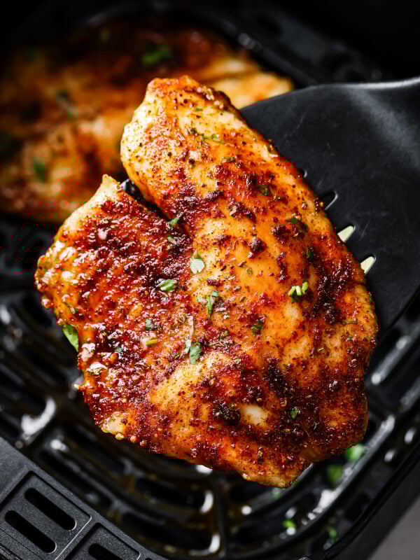 Close-up of a tilapia fillet on a spatula.