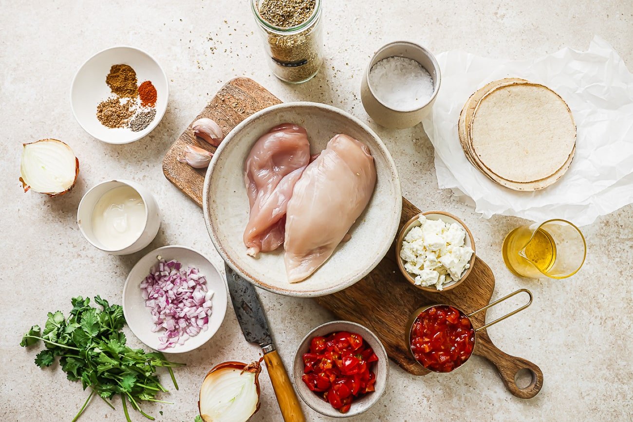 overhead view of ingredients on a countertop to make shredded chicken tacos