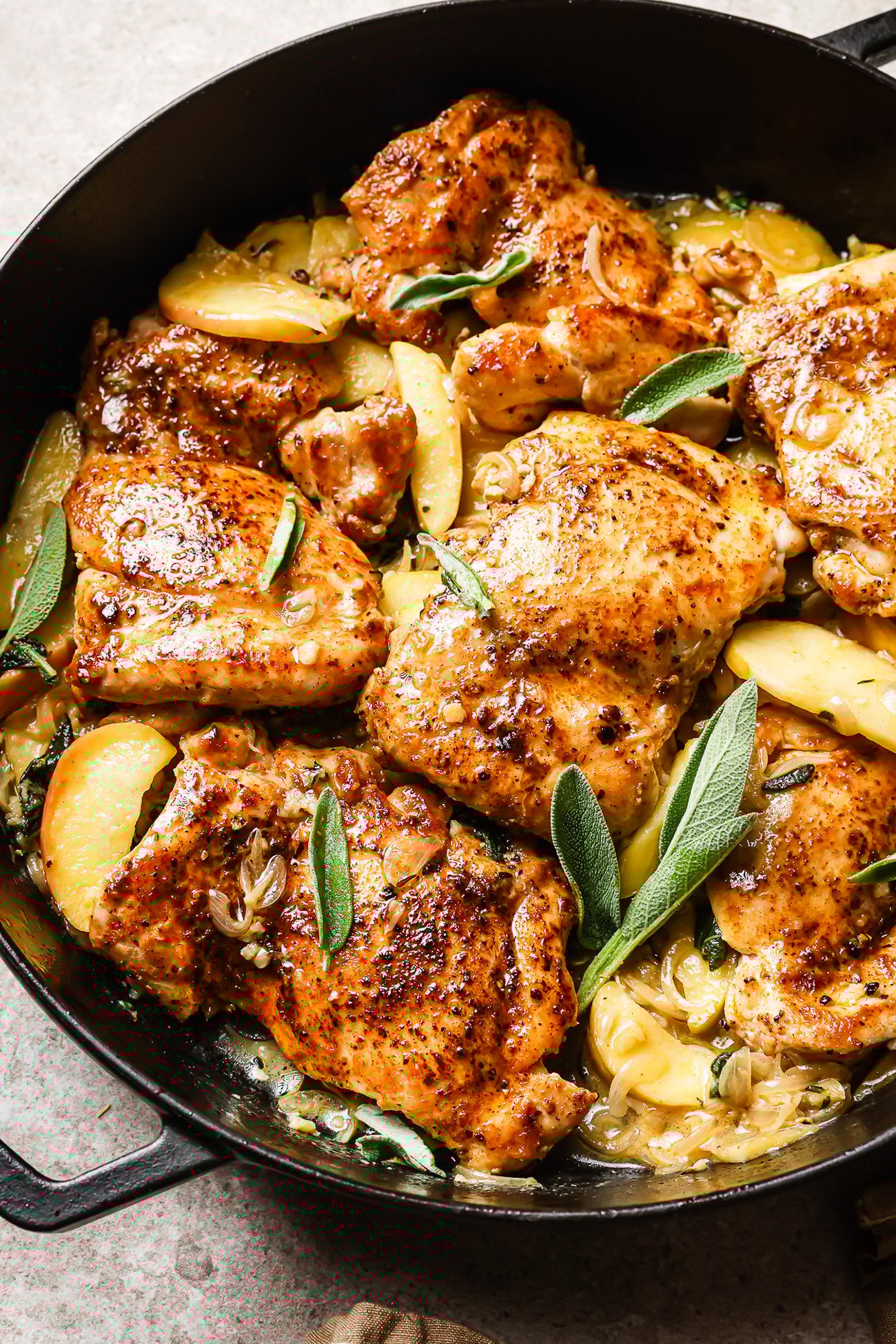 Apple cider chicken in a cast iron skillet.