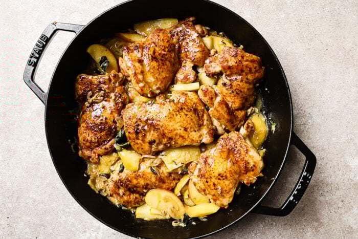 apple cider chicken in a cast iron skillet.