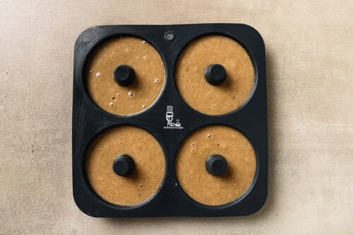 Donut batter in a donut baking pan.