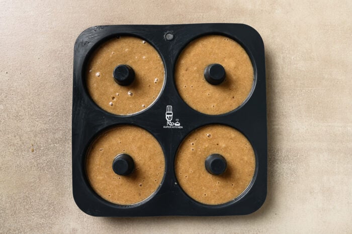 Donut batter in a donut baking pan.