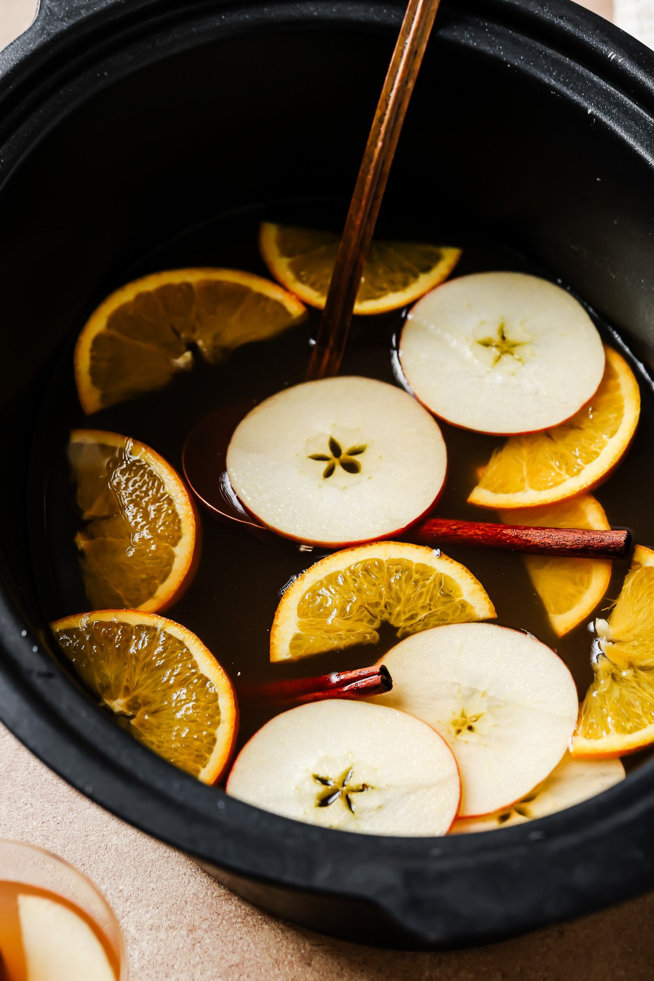 Homemade apple cider in a slow cooker bowl.