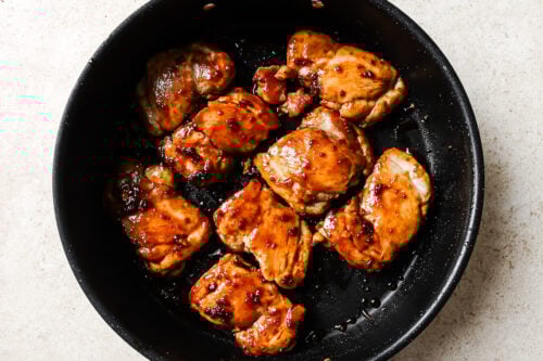 cooked chicken thighs in a skillet