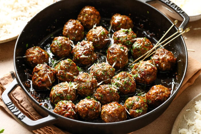 closeup view of honey garlic meatballs in a cast iron skillet