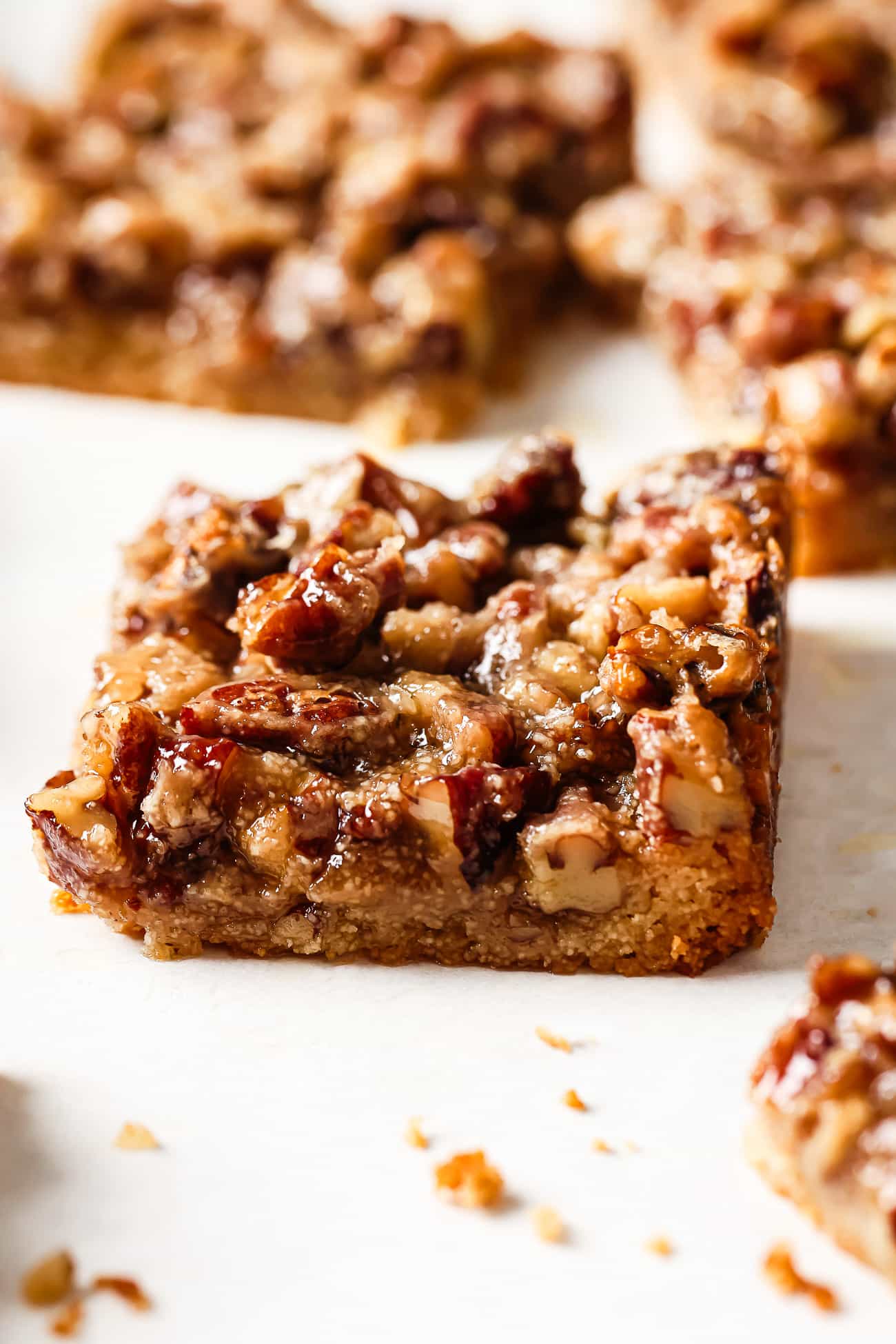 Close up of pecan pie bars on a countertop.