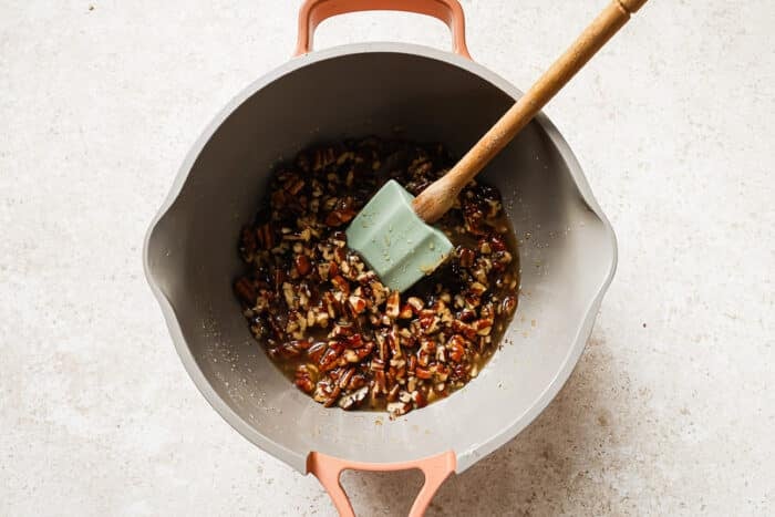 saucepan with melted butter, maple syrup, sugar, vanilla, salt, chopped pecan and milk.
