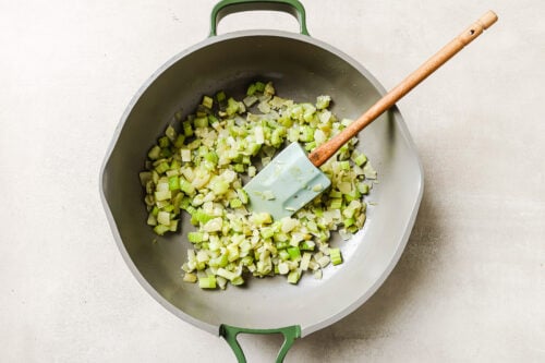 Golden sautéed onions inside a skillet.