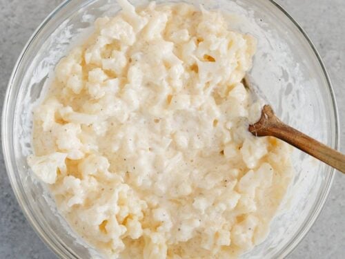 cheese mixture and cauliflower in a glass bowl.