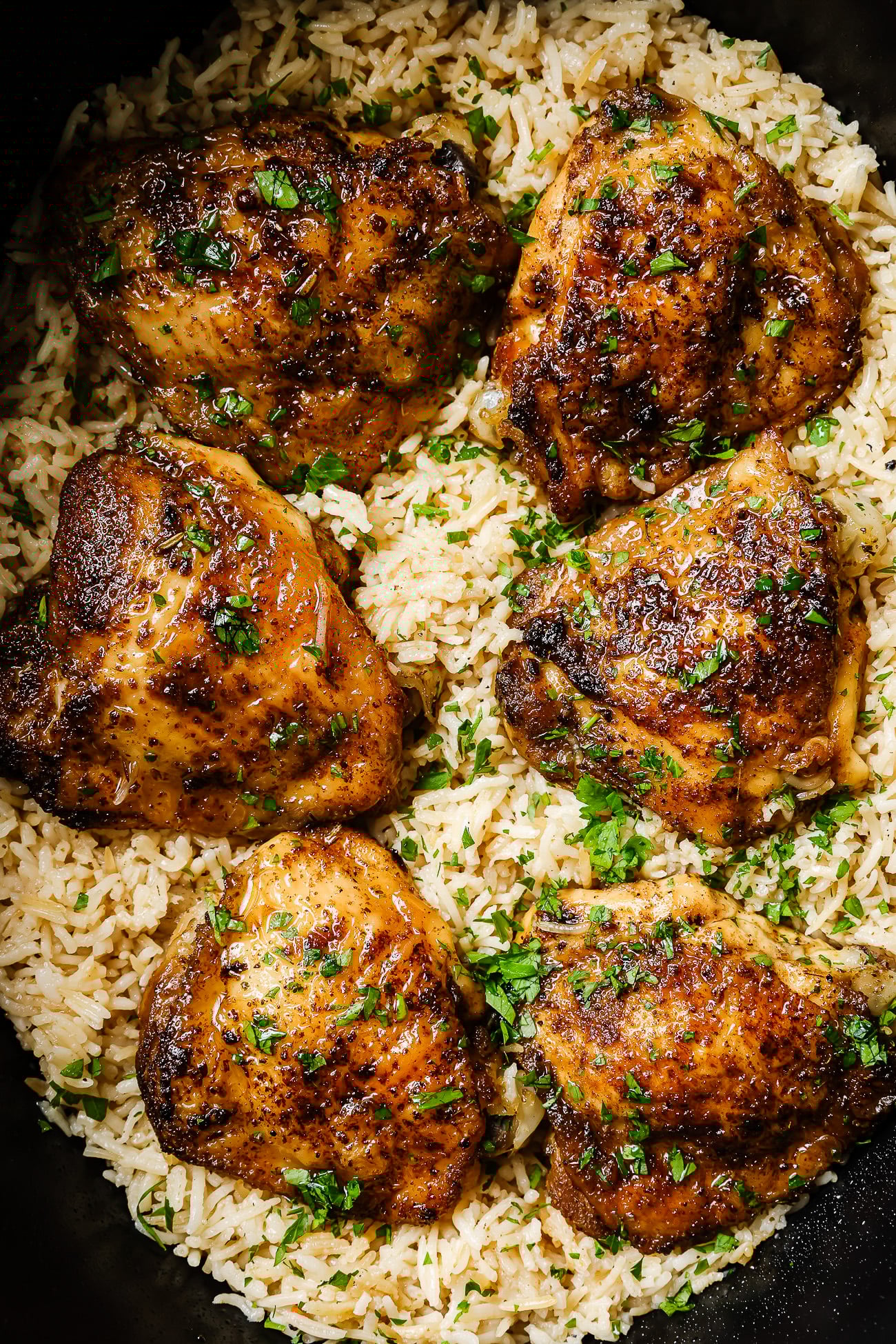 closeup of chicken and rice inside of a slow cooker bowl.