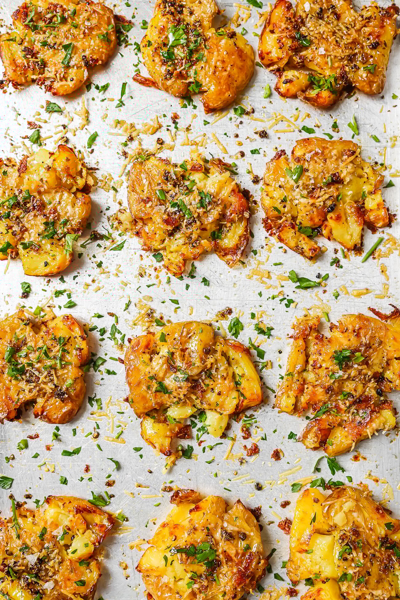 smashed potatoes on a baking sheet.