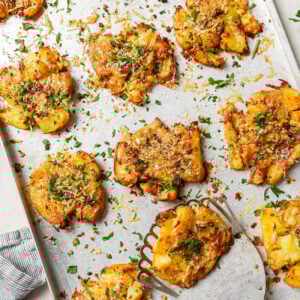smashed potatoes on a baking sheet.