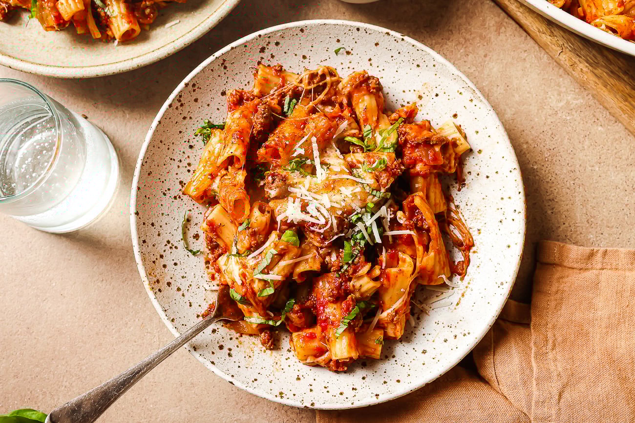 overhead view of baked rigatoni with ground beef on a plate.